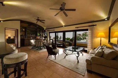 a living room with a couch and chairs at Club del Mar Oceanfront in Jacó