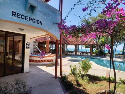 a resort with a swimming pool and a building at Hotel Las Brisas del Pacifico in Sámara