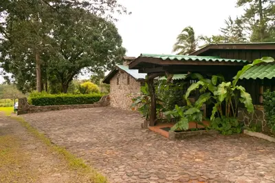 a house with a stone walkway next to a building at Malekus Mountain Lodge in Aguas Claras