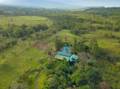 an aerial view of a house in a field at Malekus Mountain Lodge in Aguas Claras