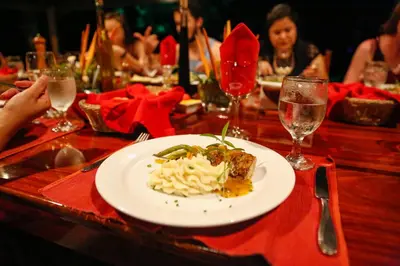 a table with a plate of food on a table at Aguila de Osa Rainforest Lodge in Drake