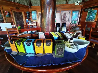 a table with a blue table cloth and food on it at Aguila de Osa Rainforest Lodge in Drake