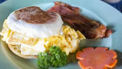 a plate of breakfast food with eggs bacon and broccoli at Aguila de Osa Rainforest Lodge in Drake
