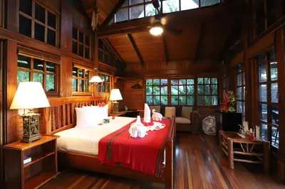 a bedroom with a bed with two animals on it at Aguila de Osa Rainforest Lodge in Drake