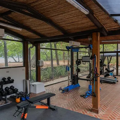 a gym with several treadmills and exercise bikes at CC Beach Front Papagayo All Inclusive in Papagayo, Guanacaste