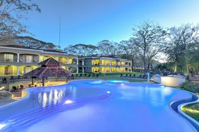a large swimming pool in front of a building at CC Beach Front Papagayo All Inclusive in Papagayo, Guanacaste