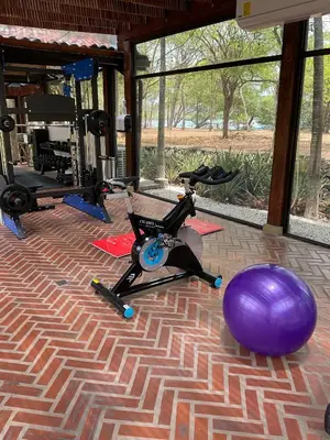a gym with a exercise bike and a purple ball at CC Beach Front Papagayo All Inclusive in Papagayo, Guanacaste