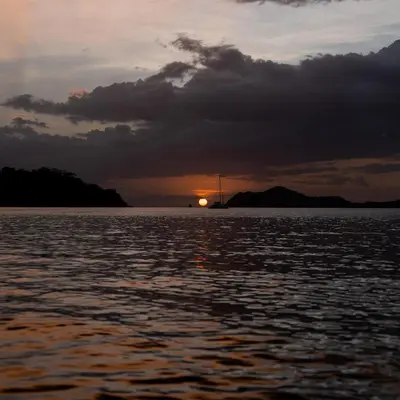 a sunset over a large body of water at CC Beach Front Papagayo All Inclusive in Papagayo, Guanacaste
