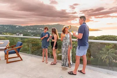 a group of people standing on a balcony at Villas Sol Beach Resort in Playa Hermosa
