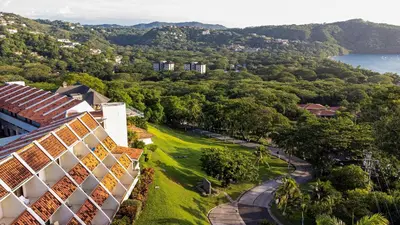 an aerial view of a building and a lake at Villas Sol Beach Resort in Playa Hermosa