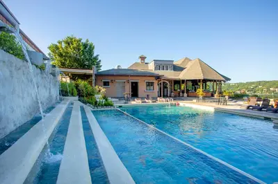 a swimming pool in front of a house at Villas Sol Beach Resort in Playa Hermosa