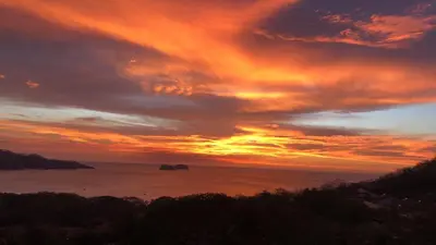 a sunset over the ocean with the sky at Villas Sol Beach Resort in Playa Hermosa