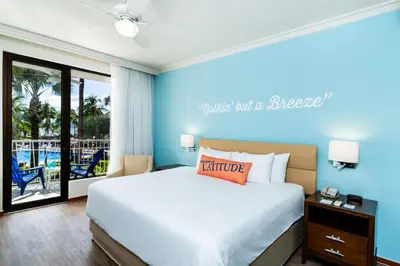 a bedroom with a large bed and a balcony at Margaritaville Beach Resort Playa Flamingo in Playa Flamingo