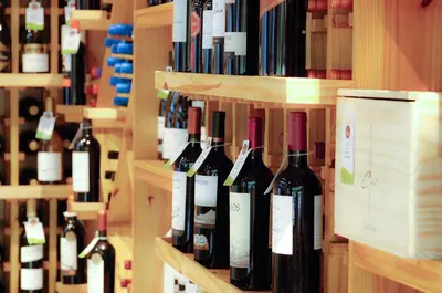 a bunch of bottles of wine on shelves in a store at Balmoral Hotel San José CR, Historic District in San José