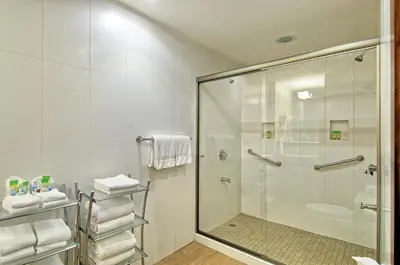 a bathroom with a shower and a glass shower stall at Balmoral Hotel San José CR, Historic District in San José