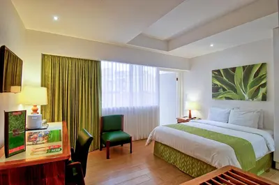 a hotel room with a bed and a desk and a chair at Balmoral Hotel San José CR, Historic District in San José