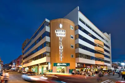 a hotel building on a busy city street at night at Balmoral Hotel San José CR, Historic District in San José
