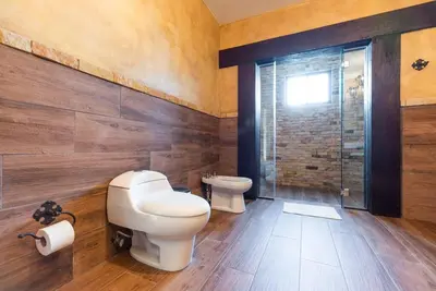 a bathroom with a toilet and a shower at Villa El Retiro Luxury Property in Alajuela City