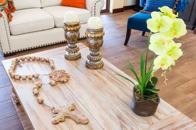 a living room with a table with a skull and flowers at Villa El Retiro Luxury Property in Alajuela City