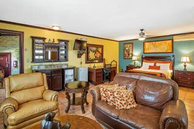 a living room with a couch and a bed at Hotel Casa Roland San Jose in San José