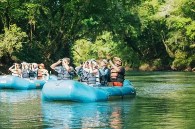 a group of people rafting down a river at Tilajari Hotel Resort in Fortuna