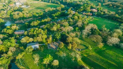 an aerial view of a house with trees and a river at Tilajari Hotel Resort in Fortuna
