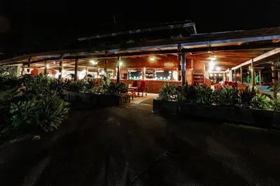 a restaurant at night with plants in front of it at Tilajari Hotel Resort in Fortuna