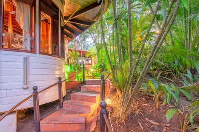 a house with a set of stairs leading to a porch at Hotel Villas Lirio in Manuel Antonio