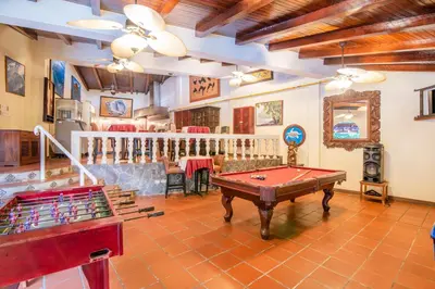 a living room with a ping pong table and billards at Hotel Villas Lirio in Manuel Antonio