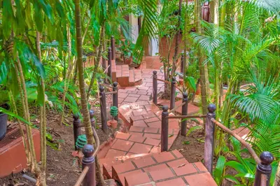 a brick path in the middle of a garden at Hotel Villas Lirio in Manuel Antonio