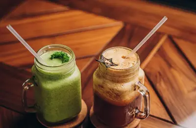 two glass mason jars filled with a green drink at Bahia del Sol Beach front Boutique Hotel in Potrero
