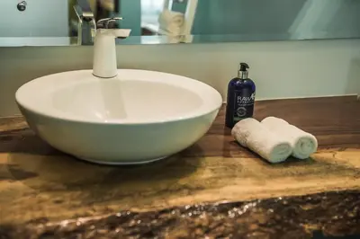 a sink and a bottle of soap and towels on a counter at Bahia del Sol Beach front Boutique Hotel in Potrero
