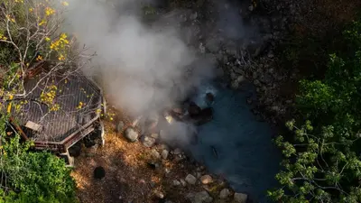 an aerial view of a steam fire next to a body of water at Borinquen Thermal Resort in Liberia