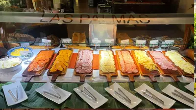 a display case with many different types of food at Hotel Los Lagos Spa & Resort in Fortuna
