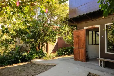 a building with a wooden door in front of it at Moon Forest Apartments in Monteverde Costa Rica