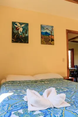 a bedroom with a bed with towels on it at Moon Forest Apartments in Monteverde Costa Rica