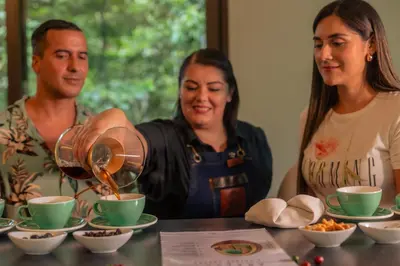 a group of three people sitting at a table drinking coffee at El Silencio Lodge & Spa Costa Rica in Toro Amarillo