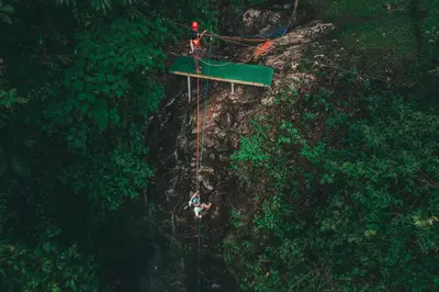 an overhead view of a person on a rope swing in the forest at El Silencio Lodge & Spa Costa Rica in Toro Amarillo