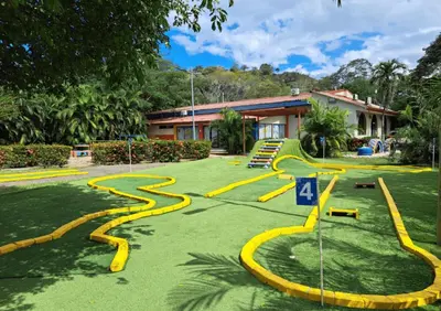 a garden with yellow curvy snakes on the grass at Nacazcol Hotel y Villas in Coco
