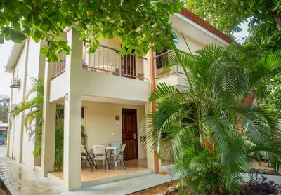 a house with a courtyard with a table and chairs at Nacazcol Hotel y Villas in Coco
