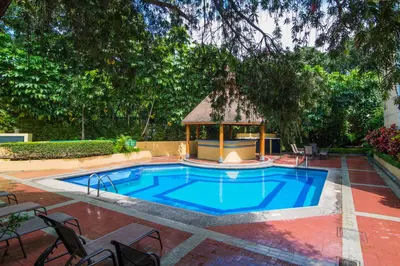 a swimming pool with a gazebo in a yard at Apartotel & Suites Villas del Rio in San José