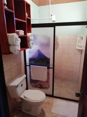 a bathroom with a toilet and a view of a mountain at Casas de Campo Las Pavitas Cottages 