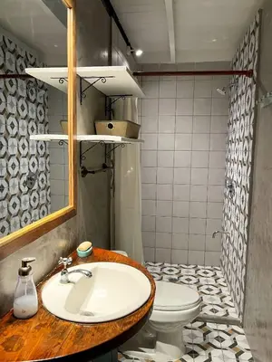 a bathroom with a sink and a toilet at Calala Lodge in Cabuya