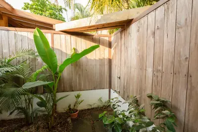 a wooden fence with a plant in front of it at Casas Santa Teresa in Santa Teresa Beach