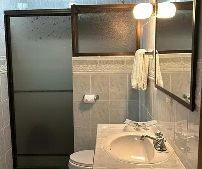 a bathroom with a sink and a toilet at Hotel Javy in Liberia