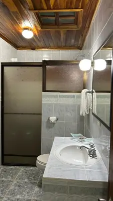 a bathroom with a sink and a toilet at Hotel Javy in Liberia
