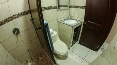 a small bathroom with a toilet and a sink at Arenal Red in Fortuna