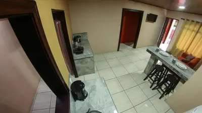 an aerial view of a living room with a table and chairs at Arenal Red in Fortuna