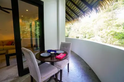 a dining room with a table and chairs and a window at Makara Mono Suite / 2nd Floor in Uvita
