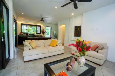 a living room with a couch and a table at Makara Mono Suite / 2nd Floor in Uvita